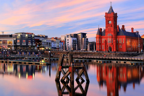 Cardiff city skyline with castle and green hills in the background